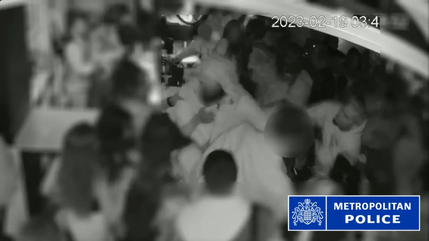 CCTV footage shows a physical altercation inside a crowded venue.