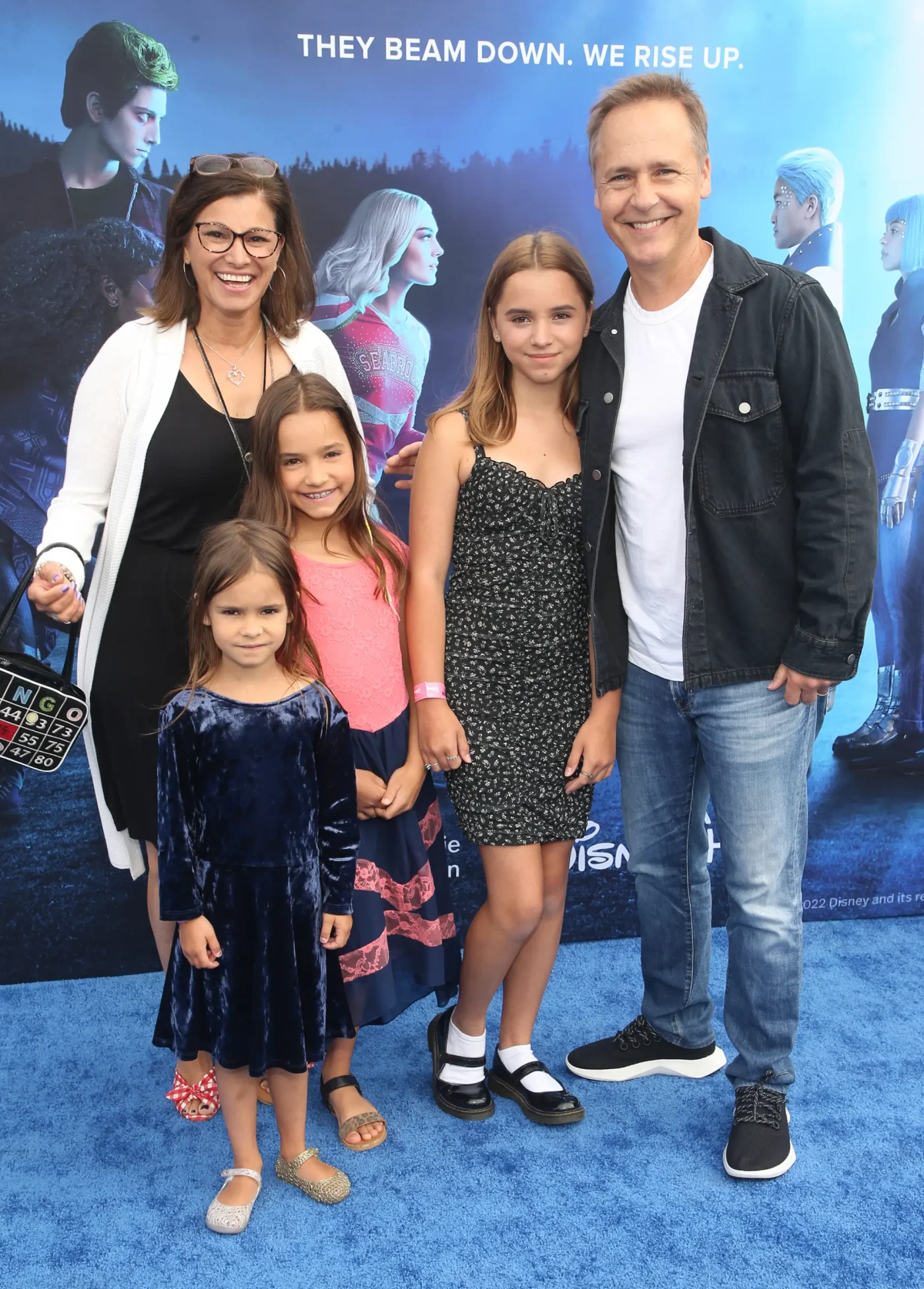 Chad Lowe, Kim Painter, and their three daughters, including Fiona Lowe, pose together on a blue carpet.