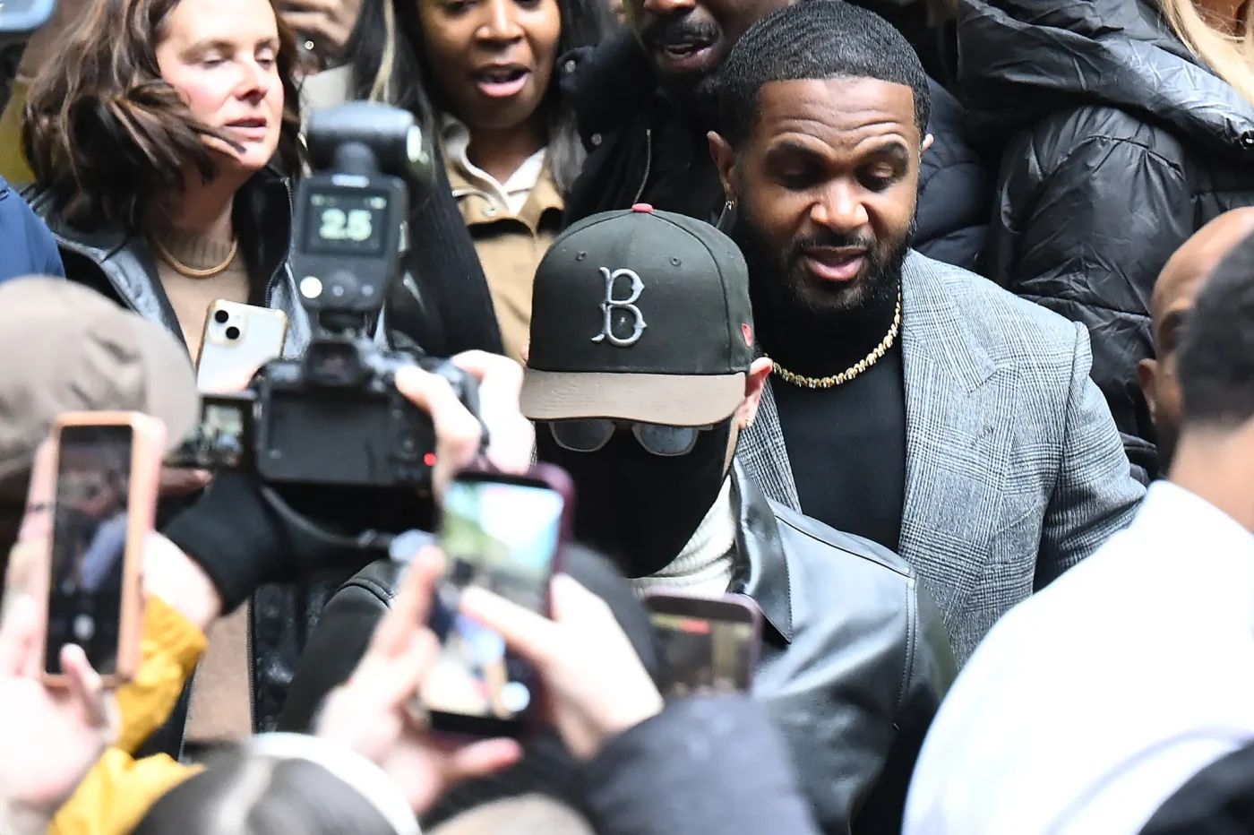 Chris Brown leaves Southwark Crown Court surrounded by media and onlookers.