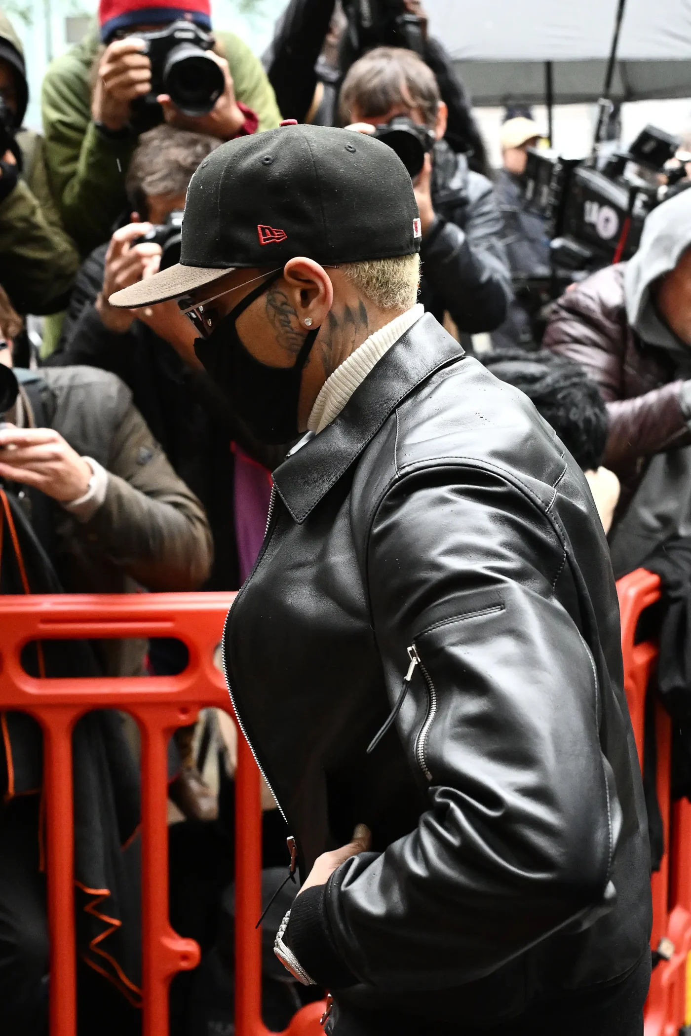 Chris Brown surrounded by photographers at Southwark Crown Court.