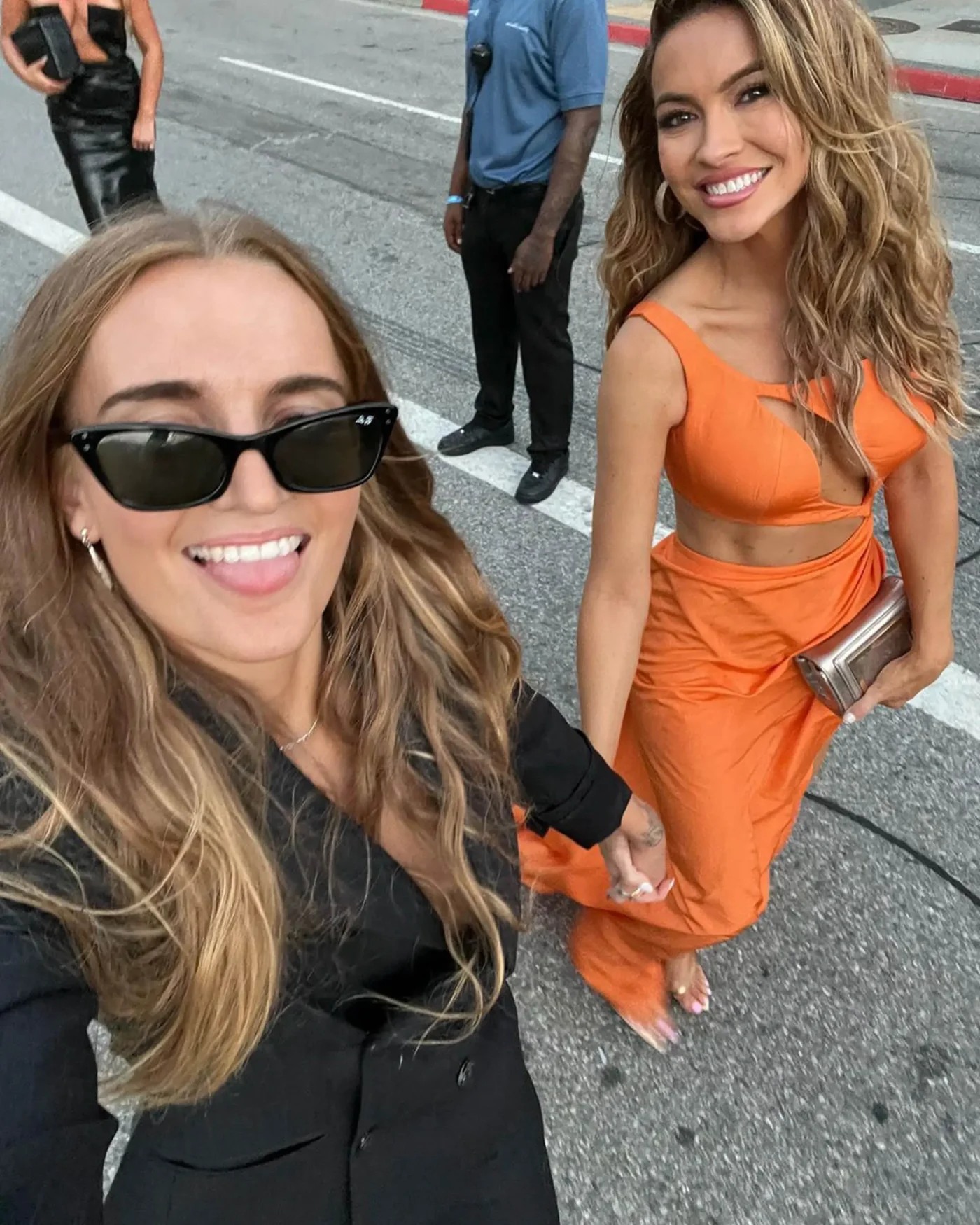 Chrishell Stause and another woman posing for a selfie in the street.