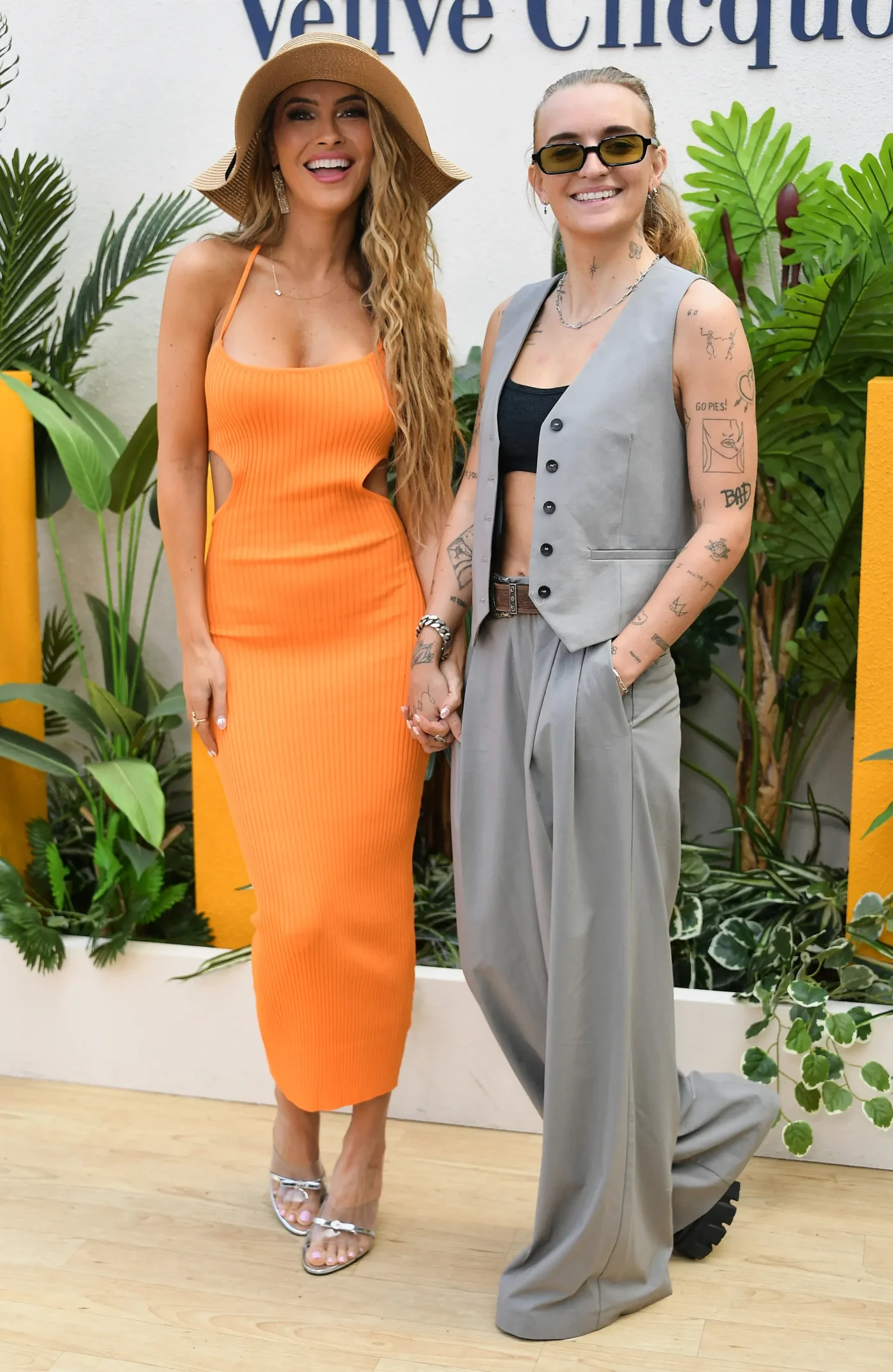 Chrishell Stause and G Flip attend an event, holding hands.