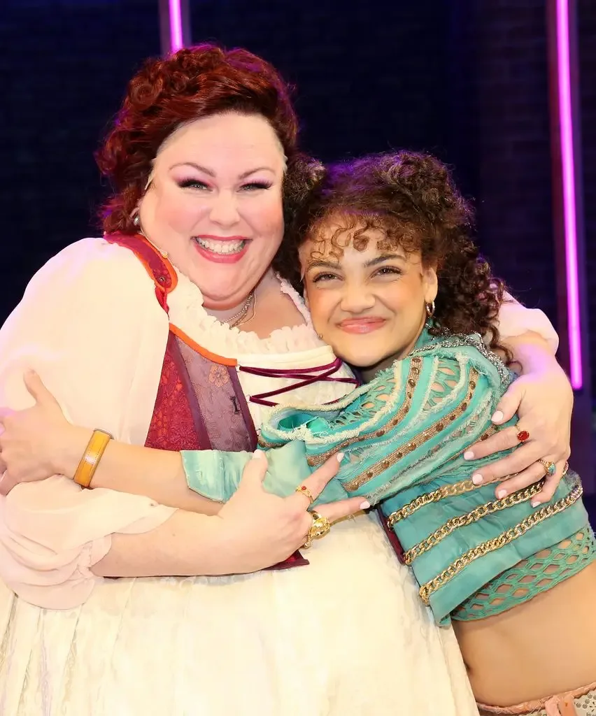 Chrissy Metz as "Angelique" and Olympic Gold medalist Laurie Hernandez as "Charmion" pose during a celebration for the hit musical comedy "& Juliet" as it welcomes Chrissy Metz to the cast and marks 1500 performances on Broadway at The Stephen Sondheim Theatre on June 23, 2026 in New York City