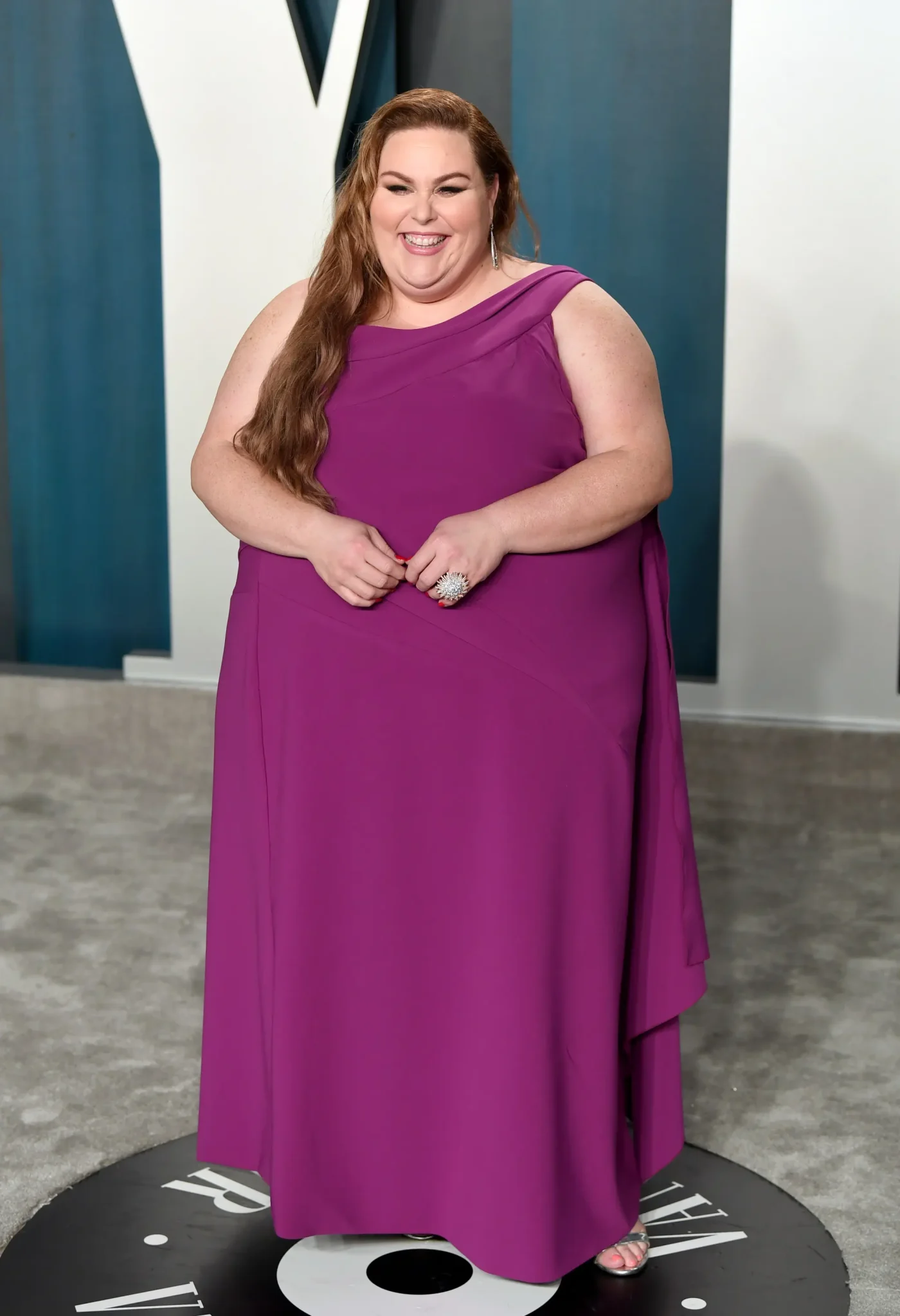 Chrissy Metz in a magenta dress at an awards party.