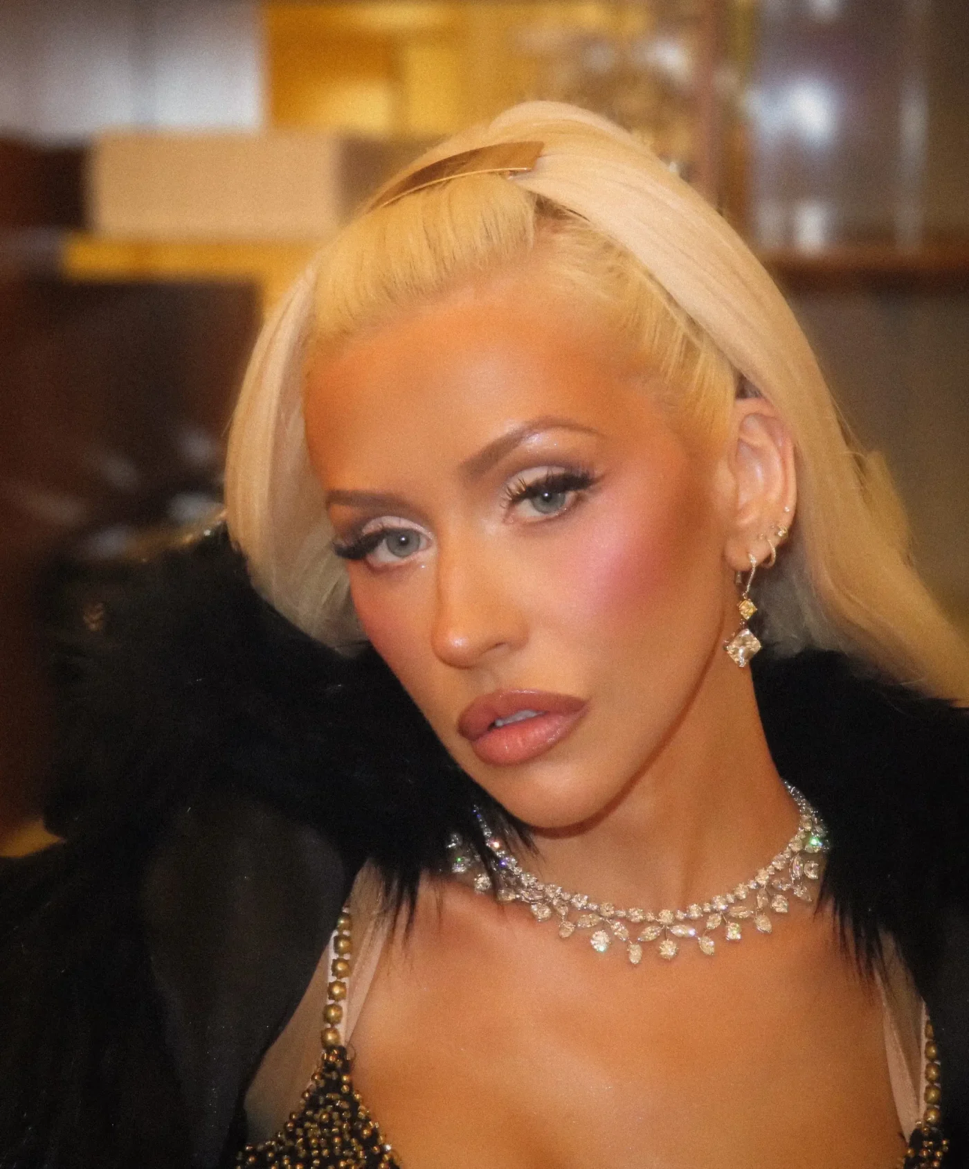 Christina Aguilera wearing a diamond necklace and earrings.
