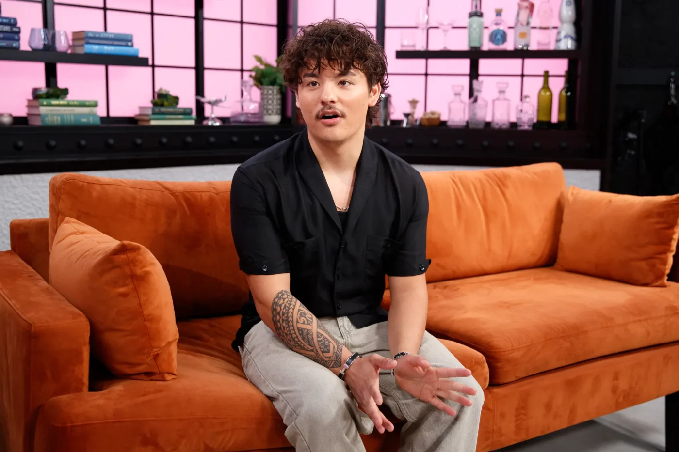 Collin Gosselin sits on an orange couch during an interview.