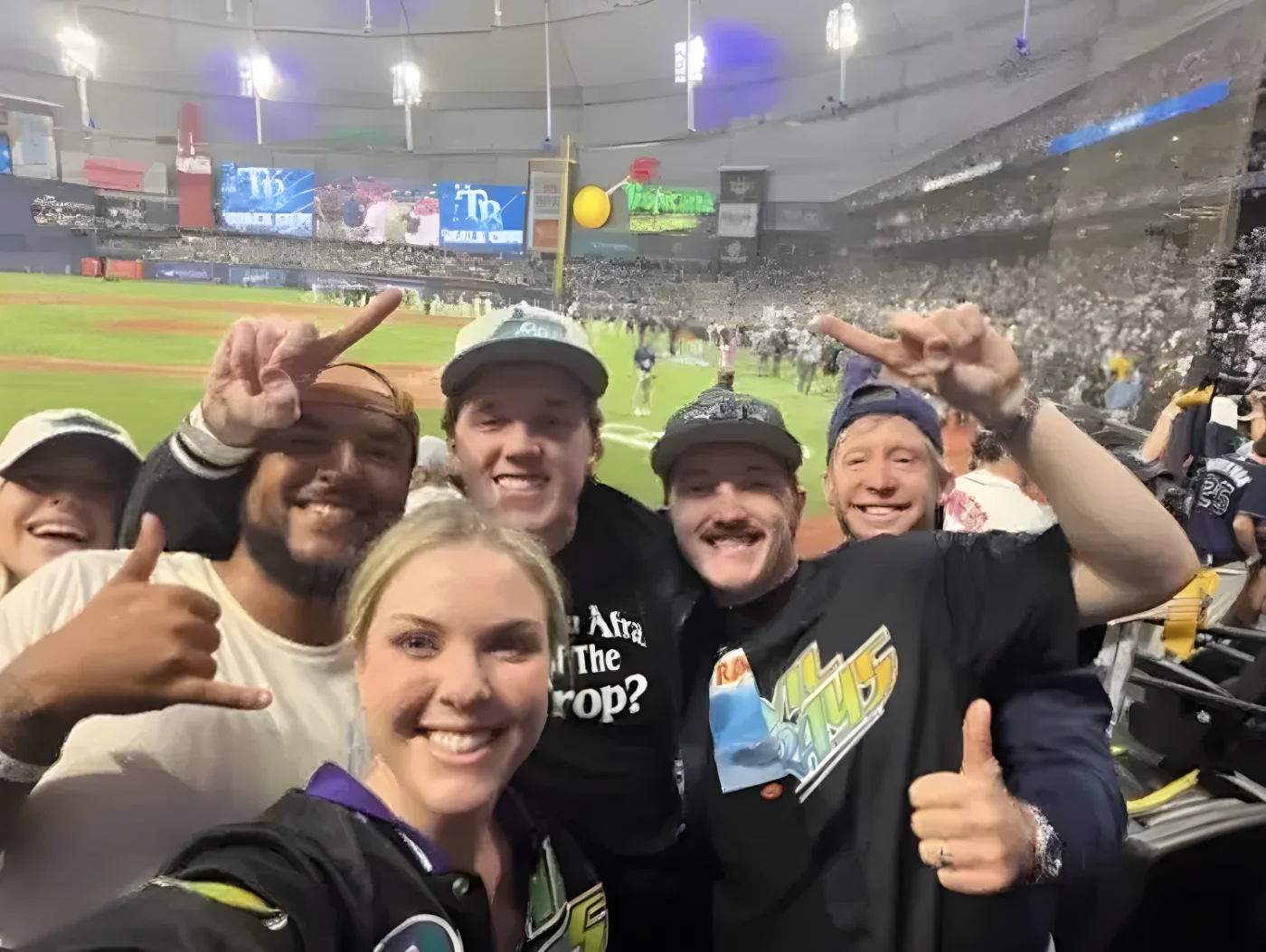 Connor Cruise smiling in group photo at baseball game