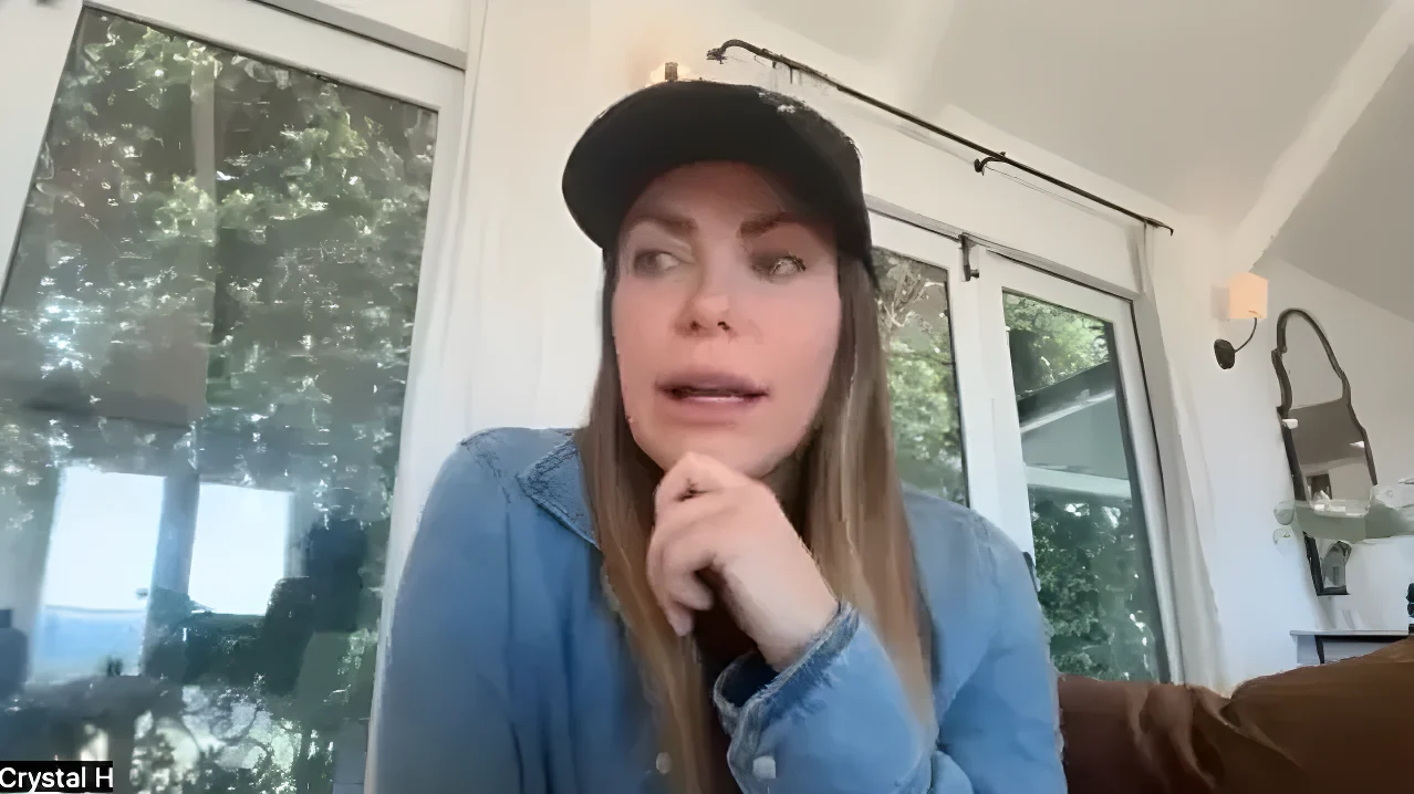 Crystal Hefner speaking during an interview in a bright room.