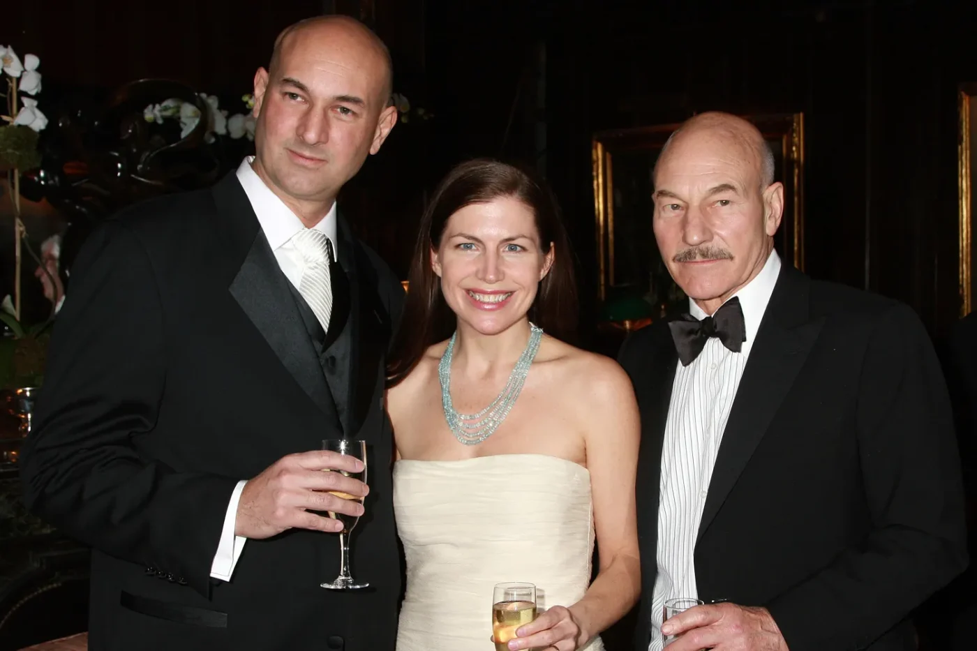 Daniel Stewart, Mary Stewart, and Patrick Stewart pose for a photo. They are all wearing black-tie attire, including Patrick, who is wearing a ribbed white dress shirt and a black bowtie beneath a black suit jacket.