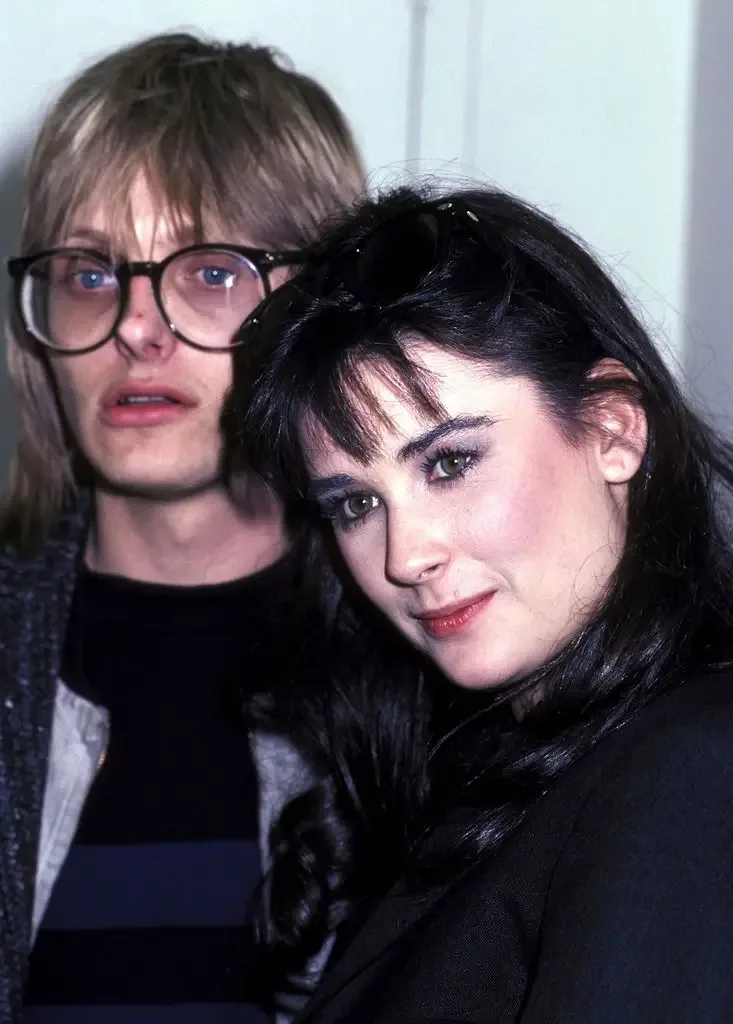 Demi Moore poses close together with her husband Freddie Moore, who wears round glasses, at an event.