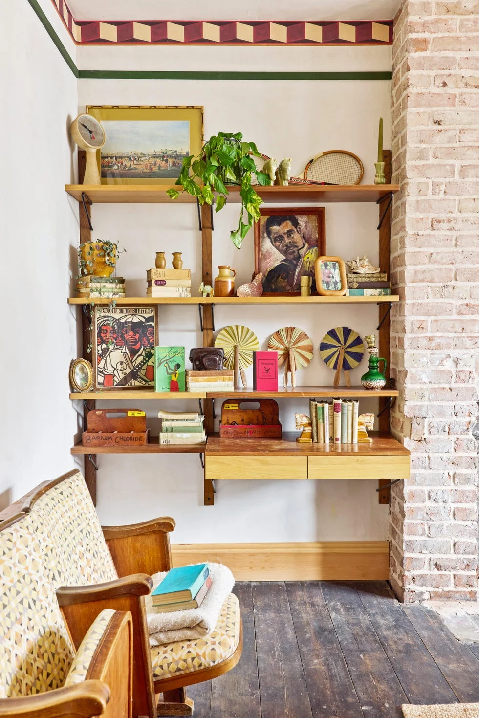 eclectic bookcase with art, books, and decorative items in a cozy room.