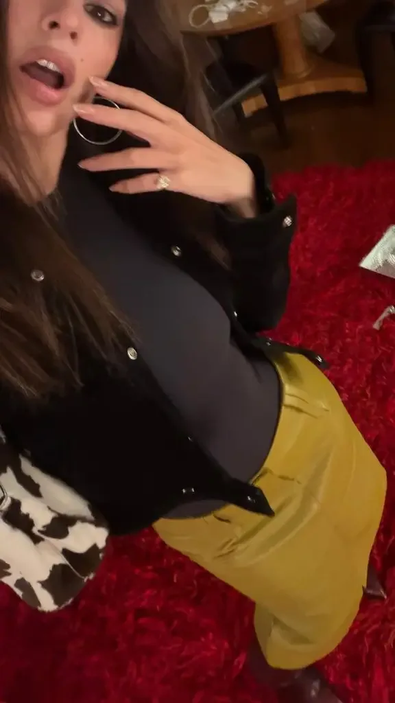 Emily wearing a leather skirt with a bodysuit