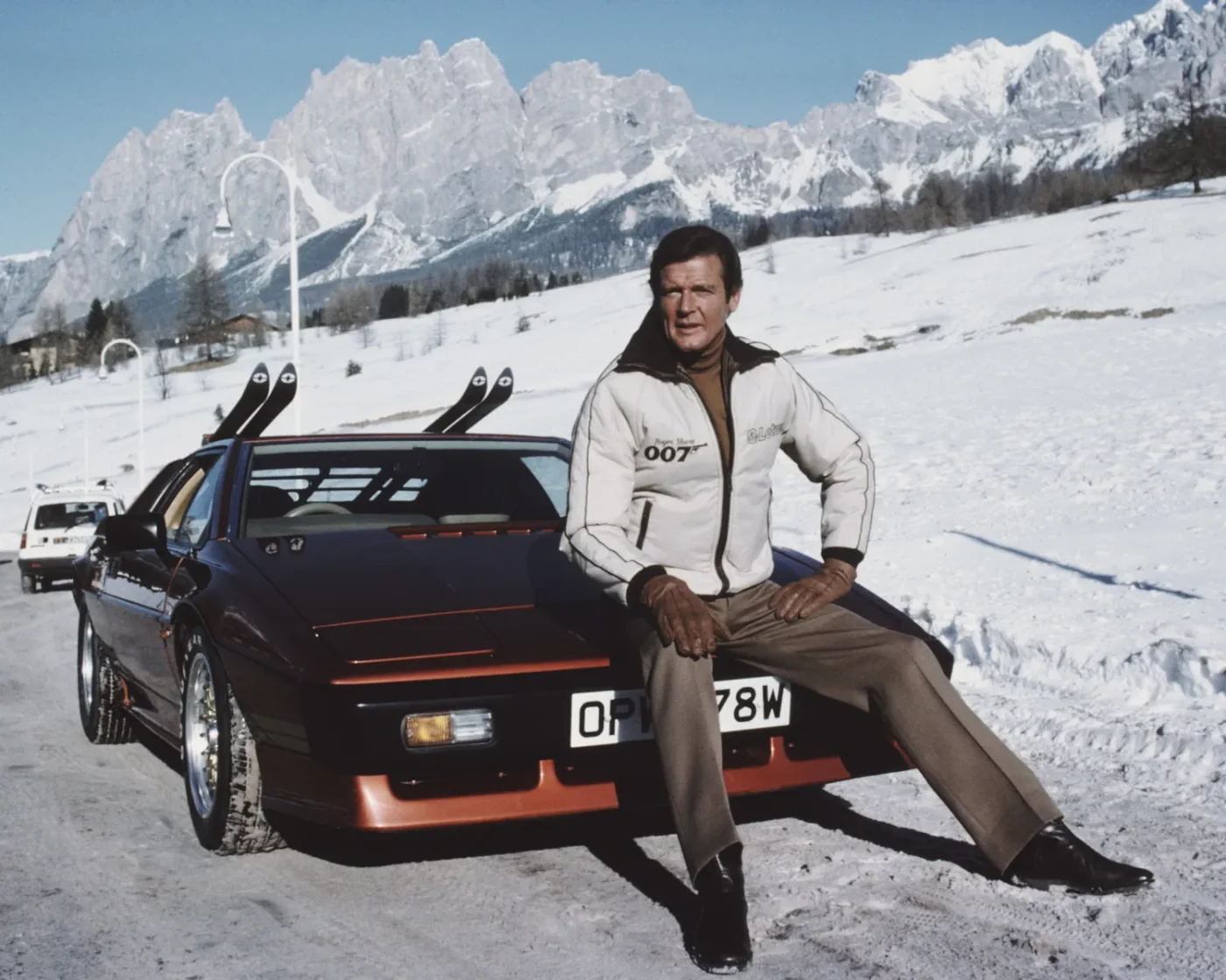 English actor Roger Moore poses as 007, with a Lotus Esprit Turbo, on the set of the James Bond film