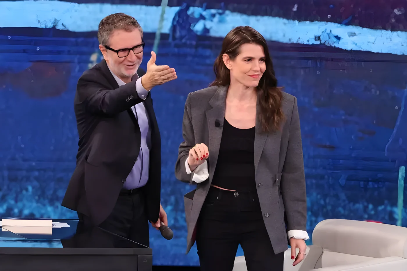 Fabio Fazio and Charlotte Casiraghi on stage, Fazio gesturing, Casiraghi smiling.