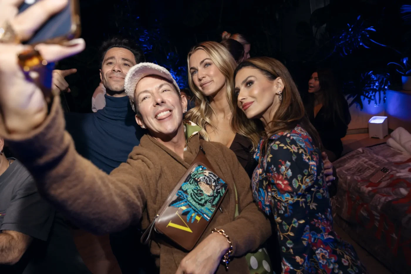 Four people take a selfie inside the Minky Couture NYC pop-up.