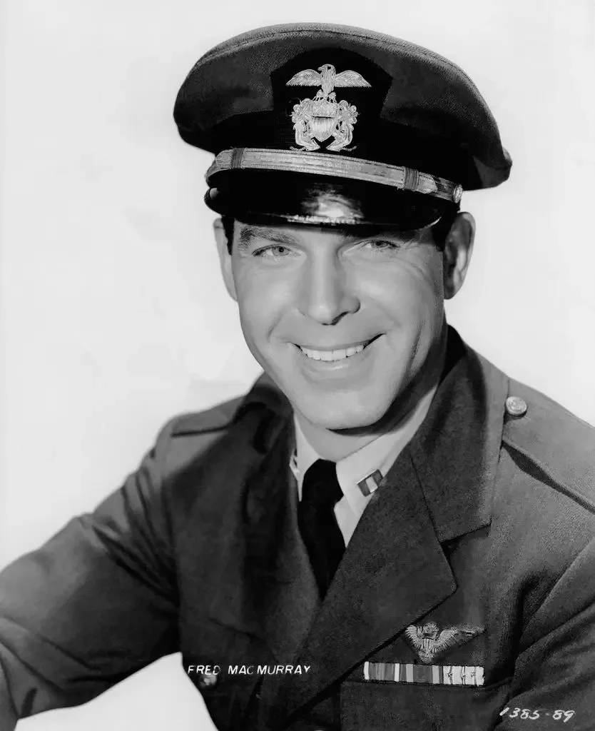 Fred MacMurray smiles in a naval officer