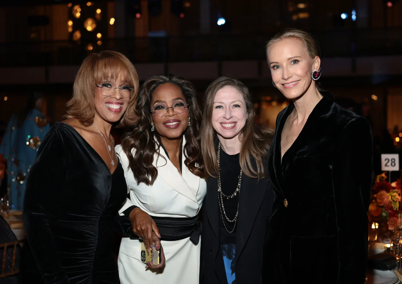 Gayle King, Oprah Winfrey, Chelsea Clinton and Amy Griffin pose together at an event.
