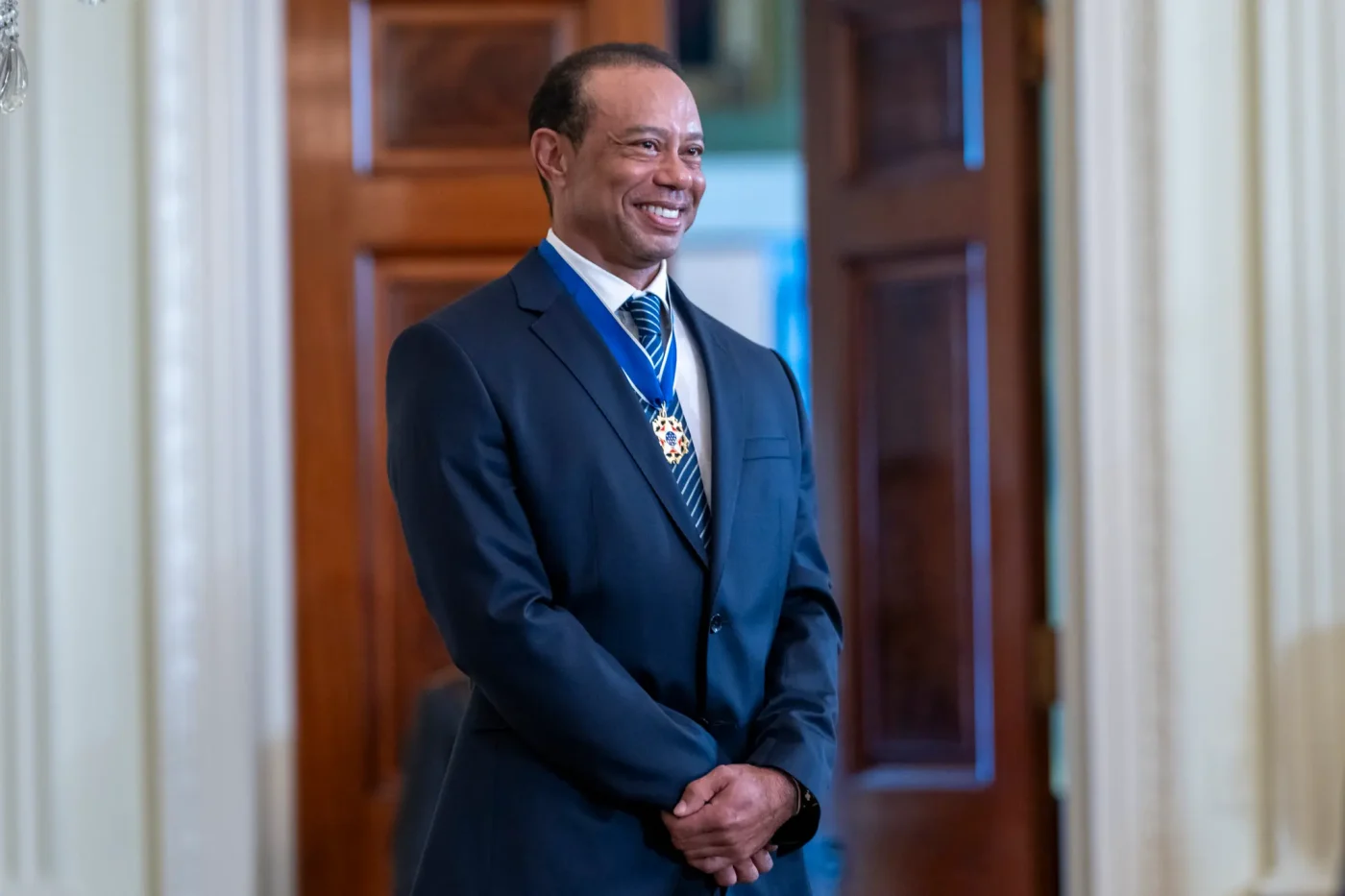 Golfer Tiger Woods smiles during a reception at the White House.