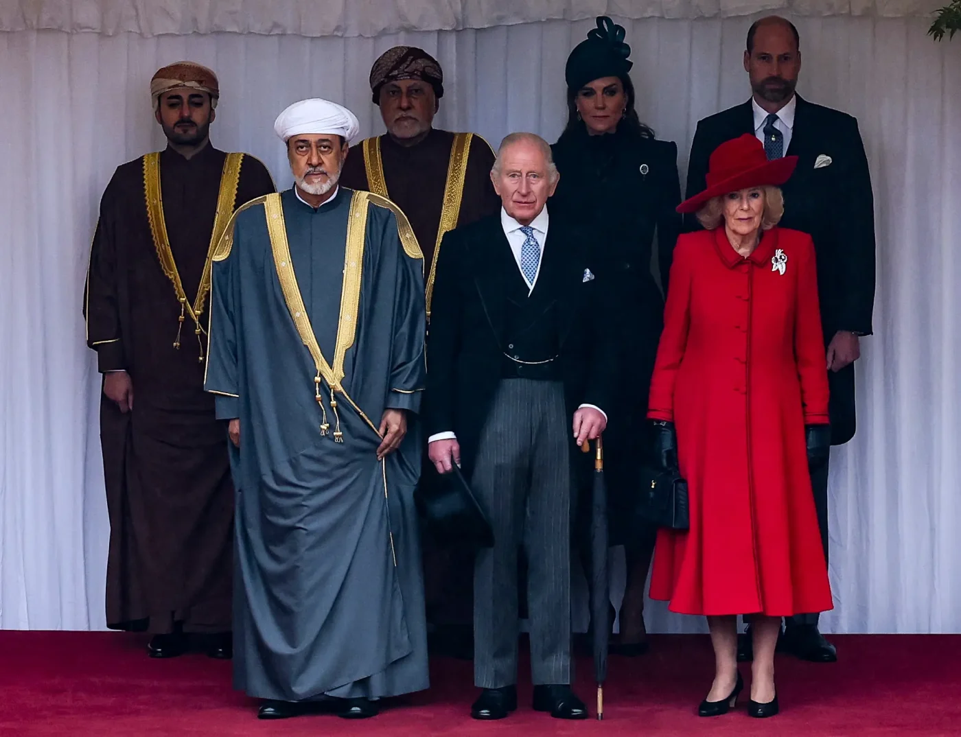 H.H. Sayyid Theyazin bin Haitham Al Said, Sultan Haitham bin Tariq Al Said, H.H. Sayyid Shihab bin Tariq Al Said, King Charles III, Catherine, Princess of Wales, Queen Camilla, and Prince William pose for a group photo in the Quadrangle of Windsor Castle.