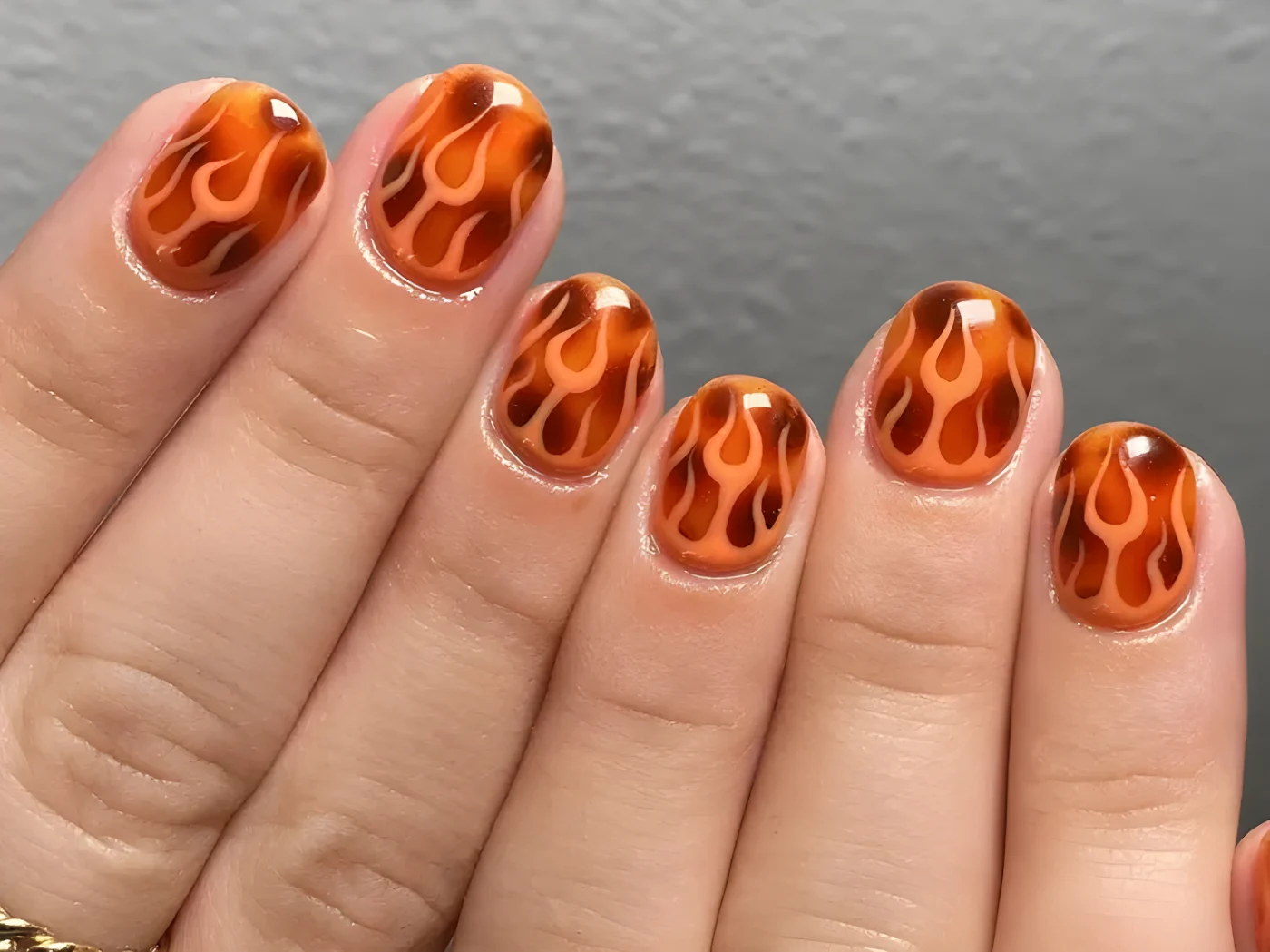 Hand showing flamethemed nail art