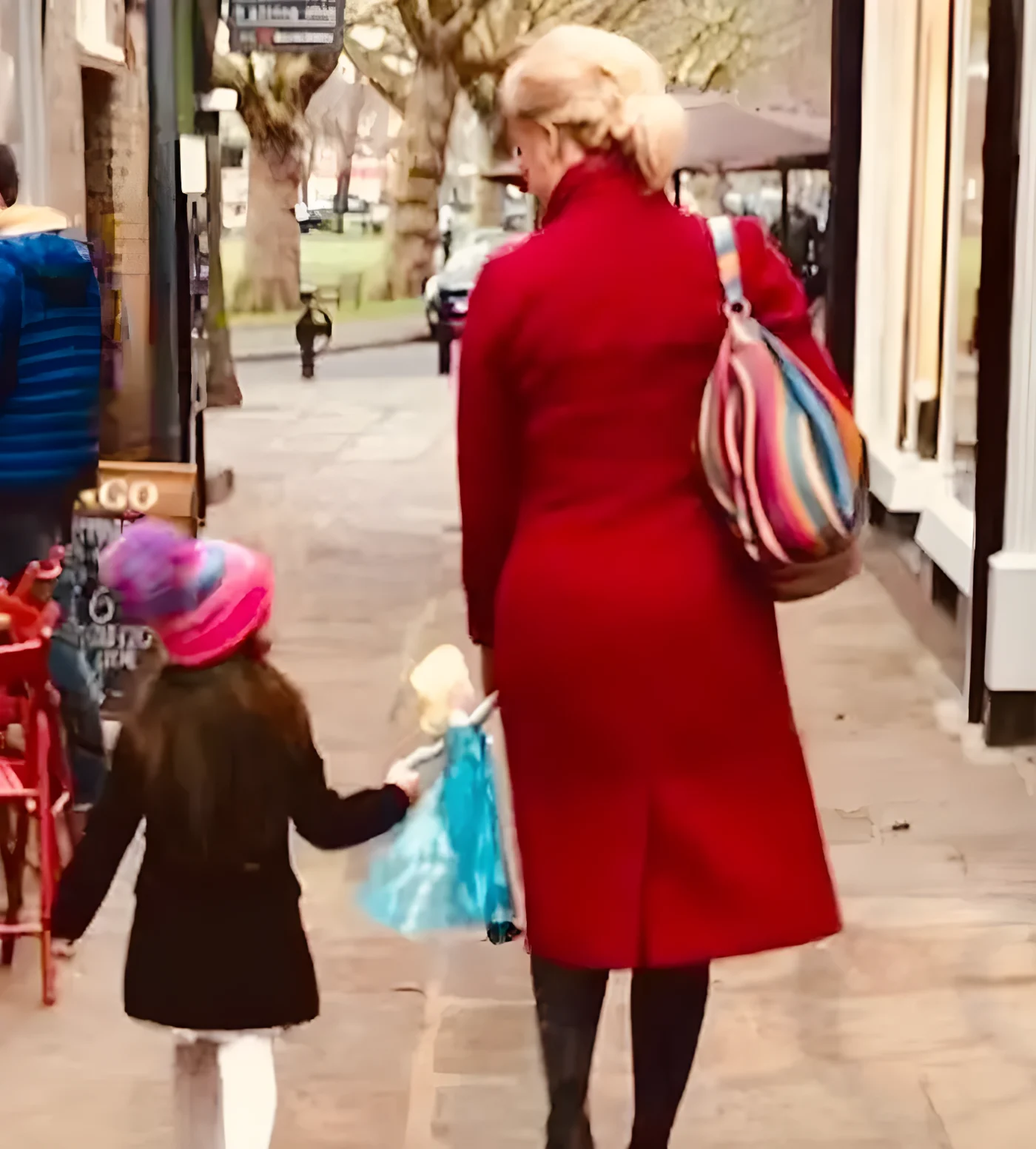 Hannah Waddingham and her daughter carrying an Elsa toy
