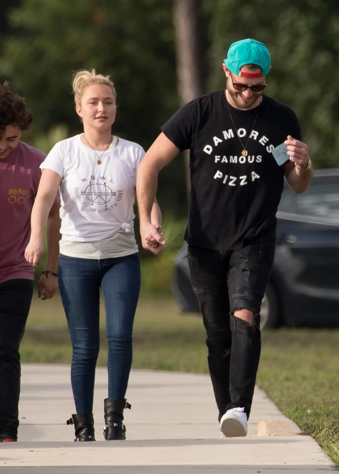 Hayden Panettiere and Brian Hickerson hold hands while walking together.