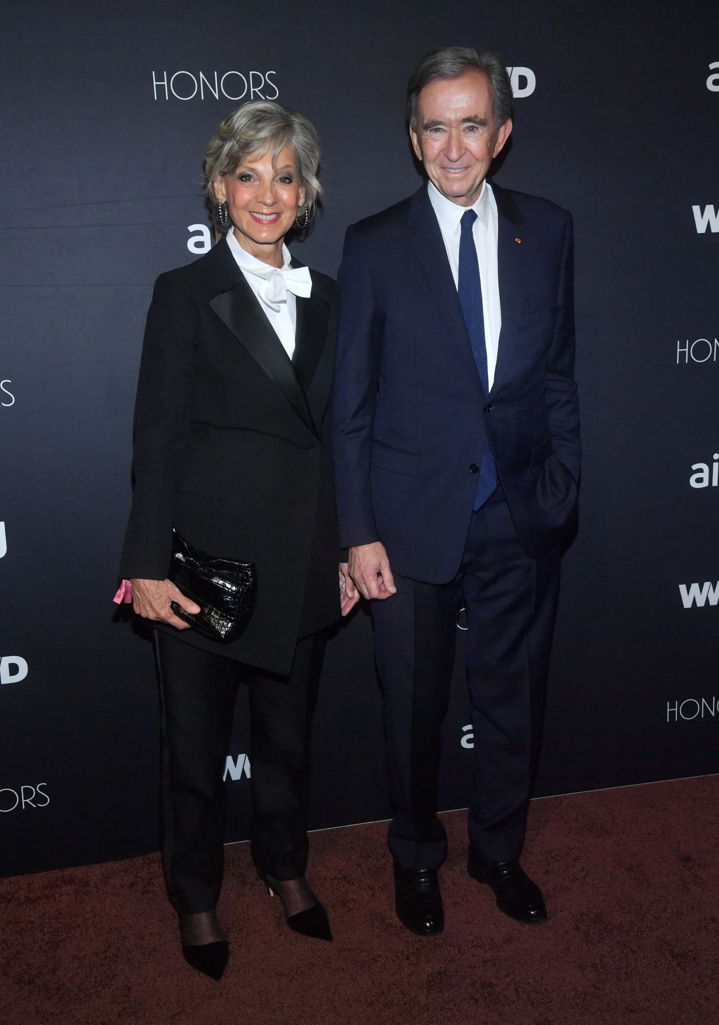 Hélène Mercier-Arnault and Bernard Arnault pose together on the red carpet at the WWD Honors.