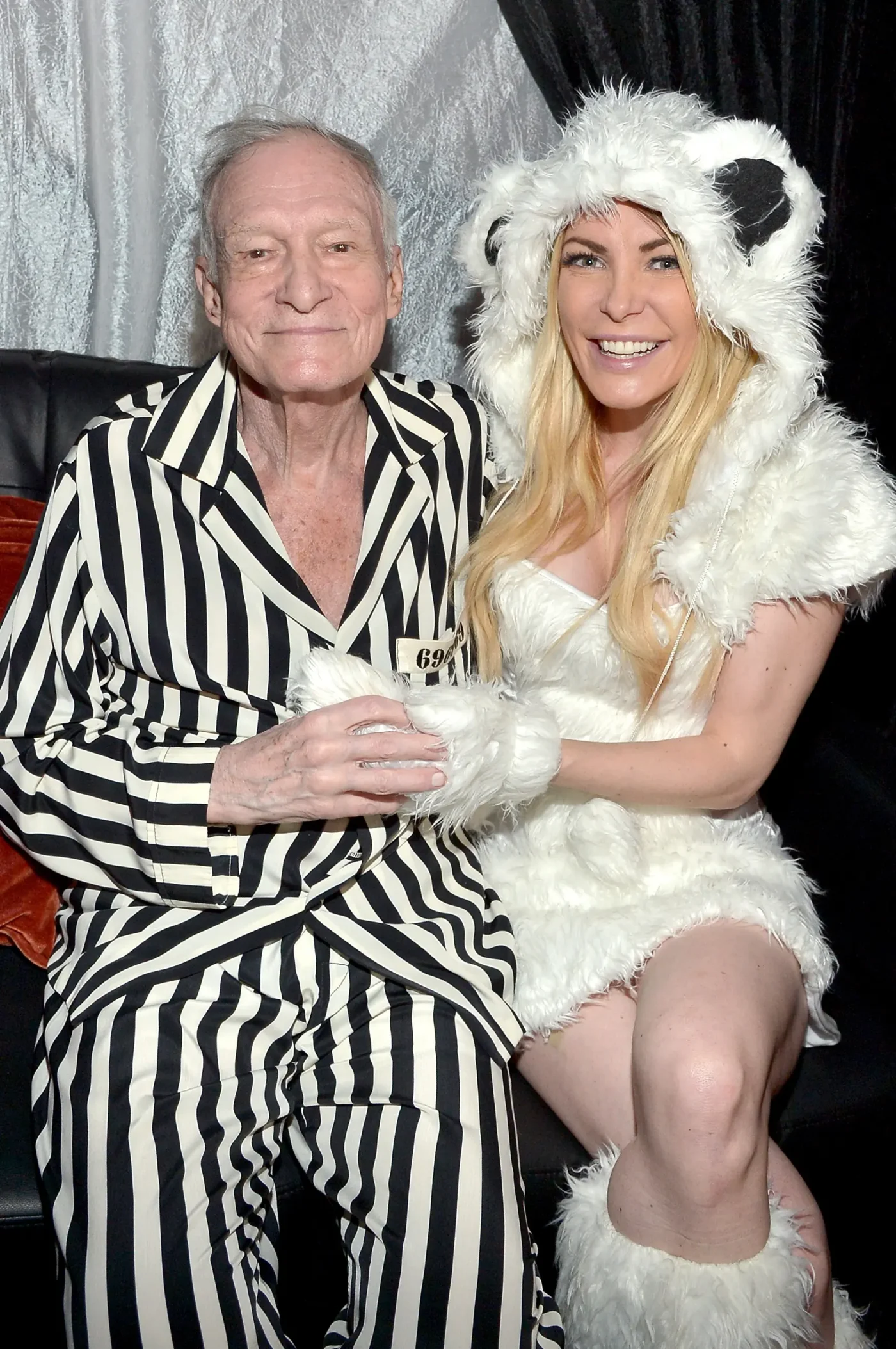 Hugh Hefner and Crystal Hefner attend a Halloween party dressed in costumes.