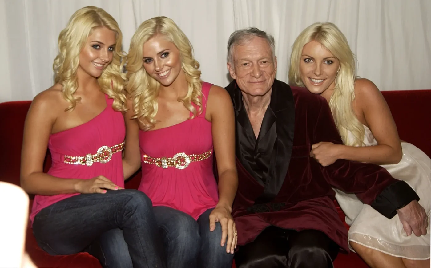 Hugh Hefner posing with Playboy Playmate twins Kristina and Karissa Shannon, and Crystal Harris.