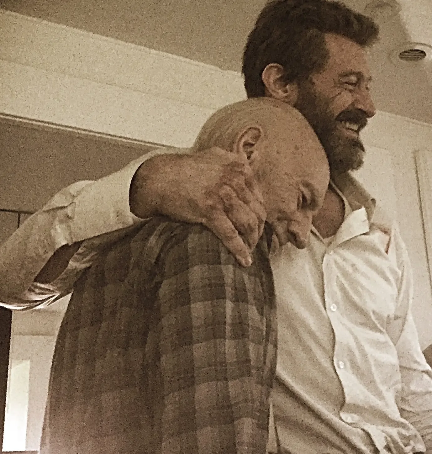 Hugh Jackman embracing Patrick Stewart.