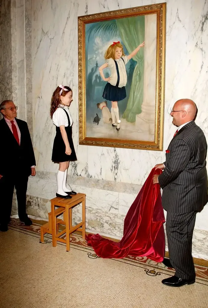 Illustrator Hilary Knight, actress Jordana Beatty, who plays Eloise in the upcoming "Eloise in Paris" movie, and General Manager Shane Krige poses during the portrait unveiling depicting the childrens literary figure "Eloise" from the Kay Thompson books on May 14, 2008 at The Plaza in New York