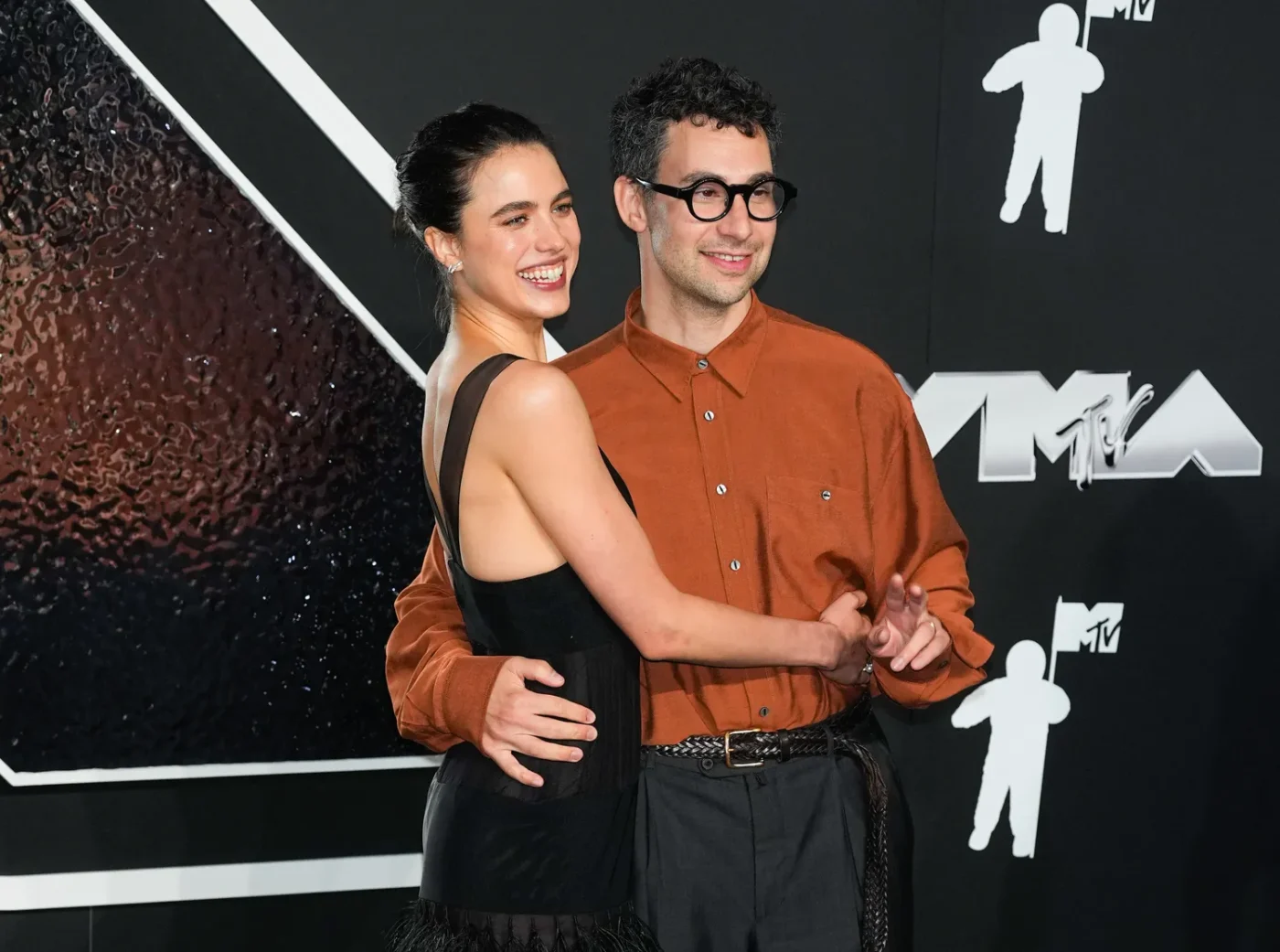Jack Antonoff and Margaret Qualley posing together while attending an event
