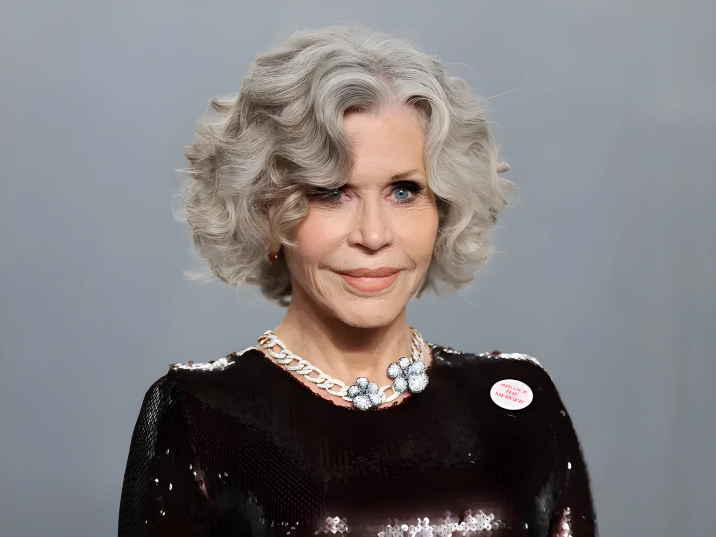 Jane Fonda attending an event wearing a sequined outfit and visible jewelry