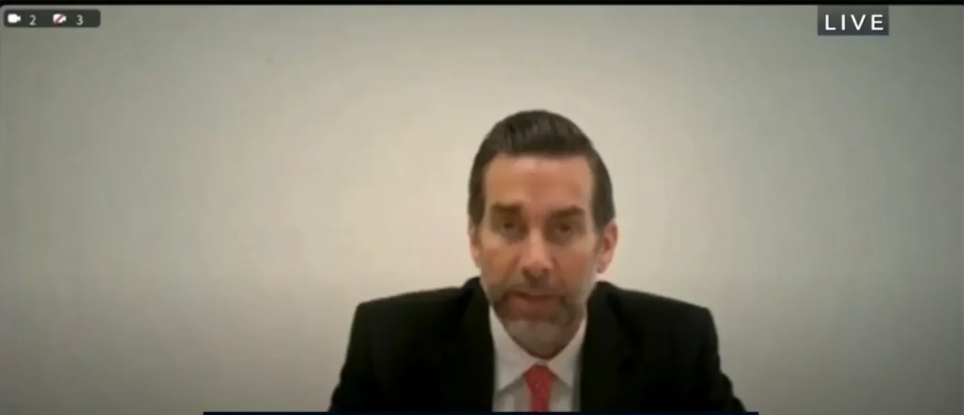 Jason Galanis testifying from prison in a live broadcast.