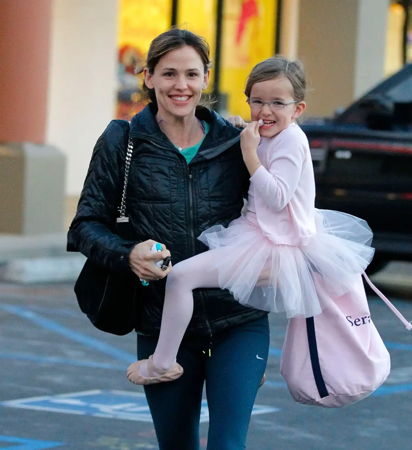 Jennifer Garner holding a young girl dressed in a ballet outfit