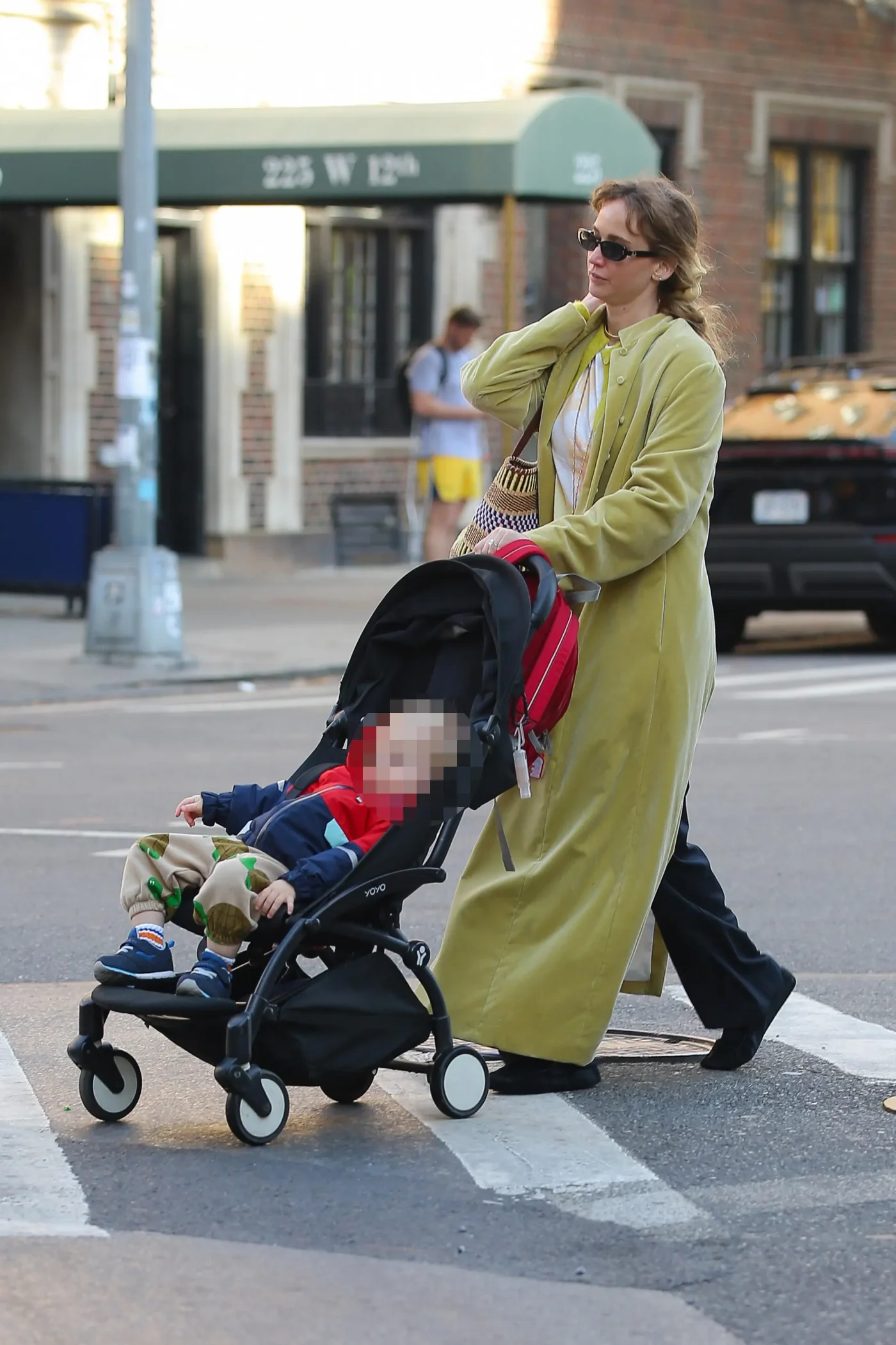 Jennifer Lawrence pushes her child in a stroller while taking a stroll in New York.