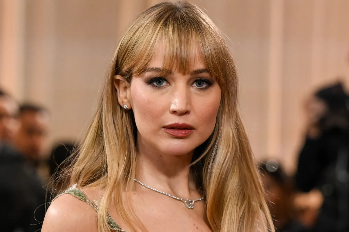 Jennifer Lawrence wearing a diamond necklace at a public appearance.