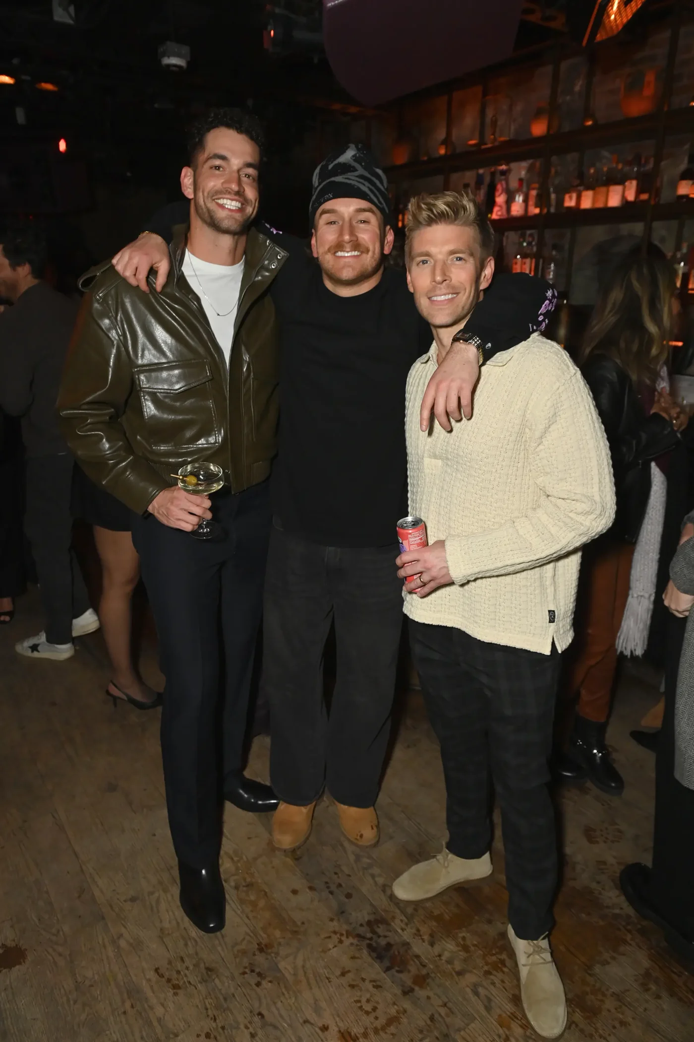 Jesse Solomon, West Wilson, and Kyle Cooke posing together indoors at an event.