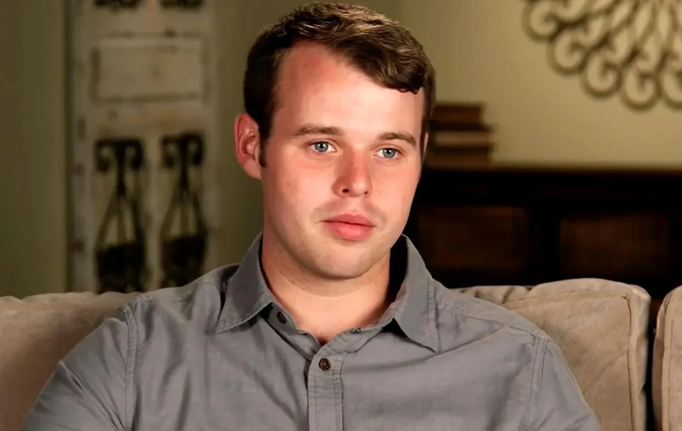 Joseph Duggar sitting on a couch.
