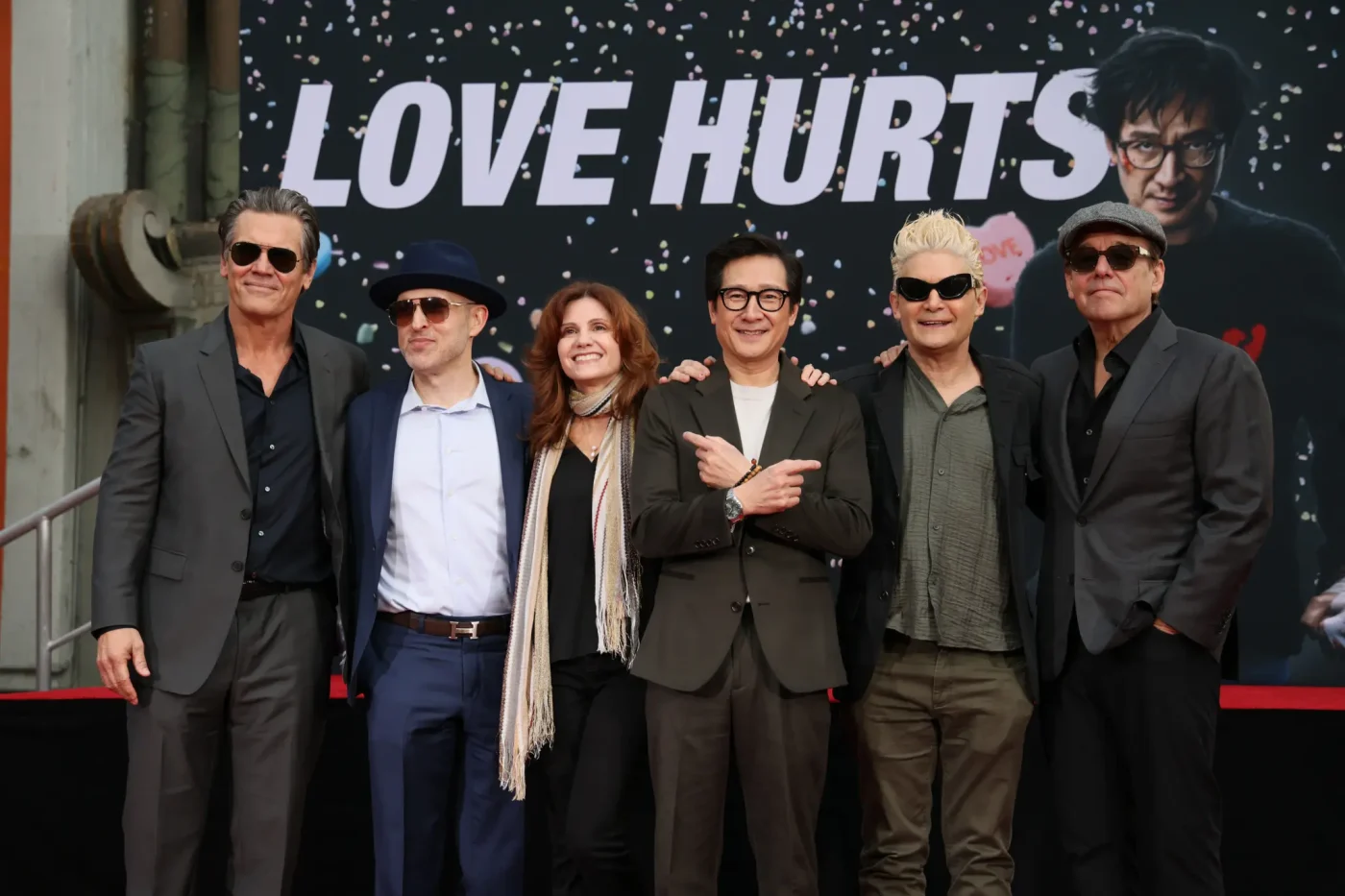 Josh Brolin, Jeff Cohen, Kerri Green, Ke Huy Quan, Corey Feldman and Chris Columbus pose in front of a