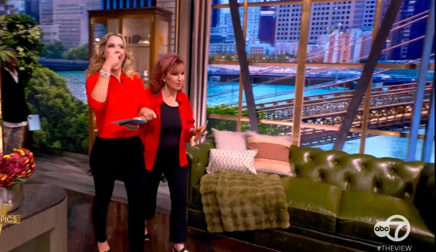 Joy Behar links arms with Sara Haines on the set of