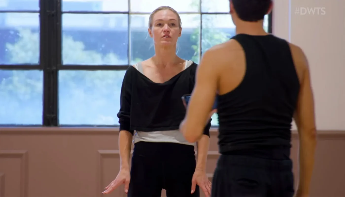 Julia Stiles and Ezra Sosa in a dance studio during a heated rehearsal.