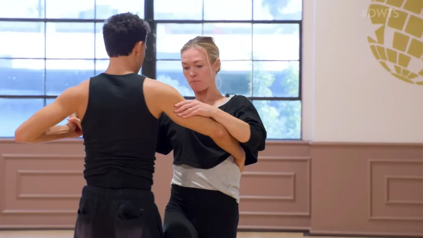 Julia Stiles and Ezra Sosa practicing a dance routine in a studio.