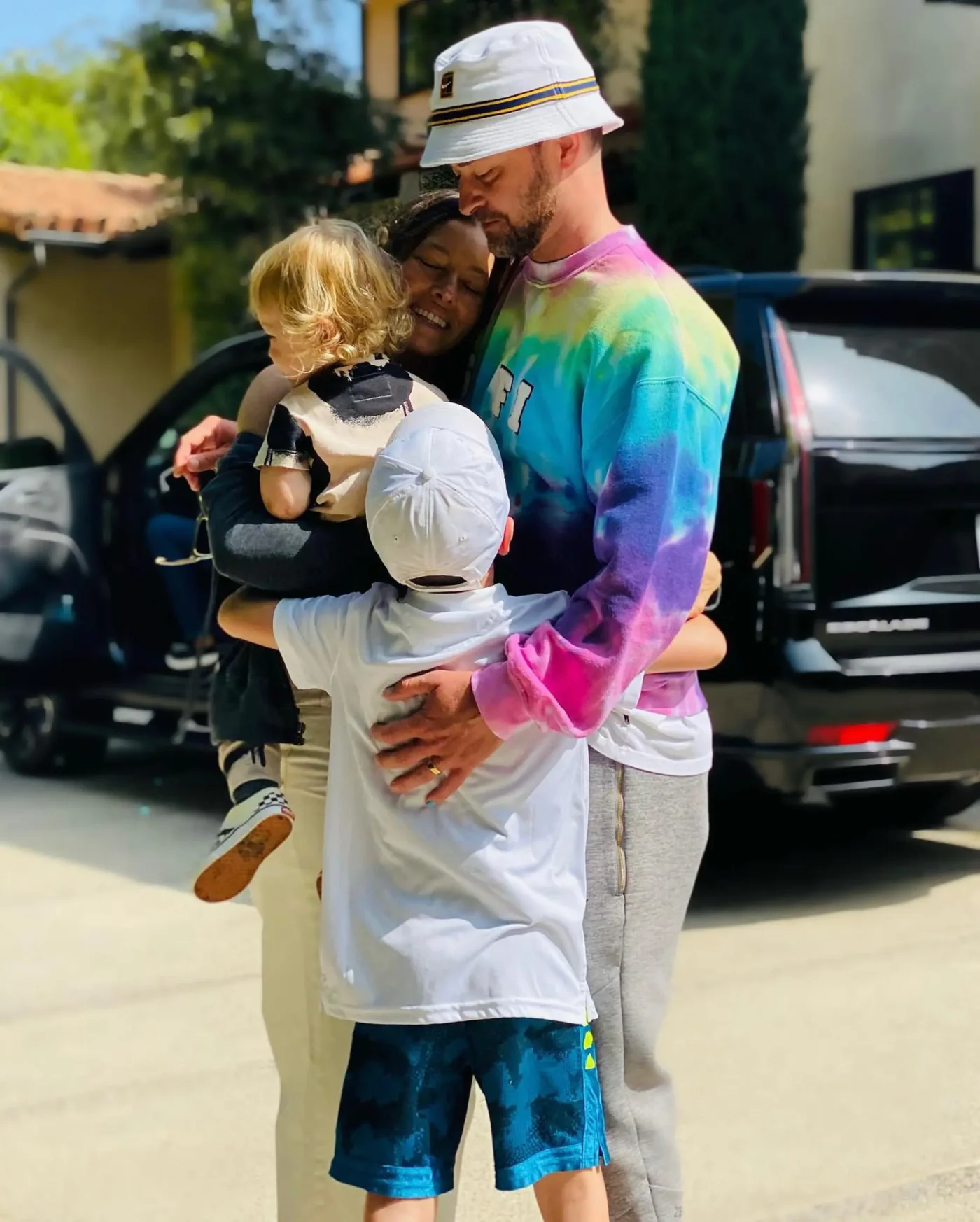 Justin Timberlake, Jessica Biel, and their kids, Silas and Phineas, embracing outdoors.