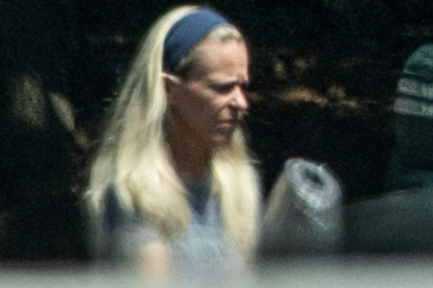 Kate Gosselin with blonde hair and a blue headband outside her home in Troutman, NC.