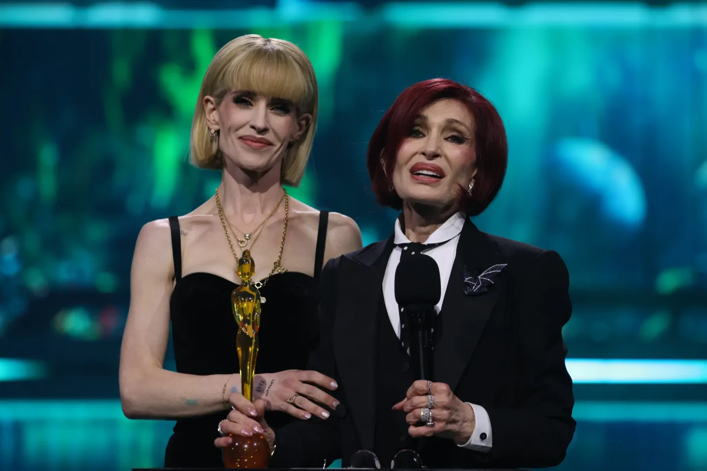 Kelly Osbourne and Sharon Osbourne accept the Lifetime Achievement award on stage at The BRIT Awards.
