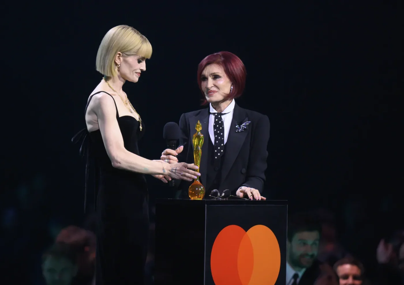 Kelly Osbourne and Sharon Osbourne accept the Lifetime Achievement Award for Ozzy Osbourne during the 2026 Brit Awards on February 28, 2026