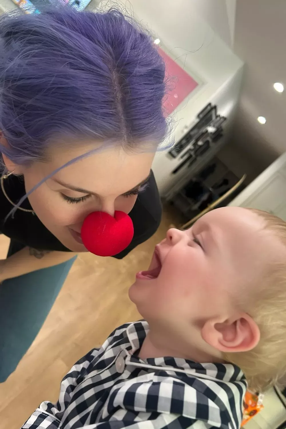 Kelly Osbourne makes her son Sidney laugh while wearing a clown nose.