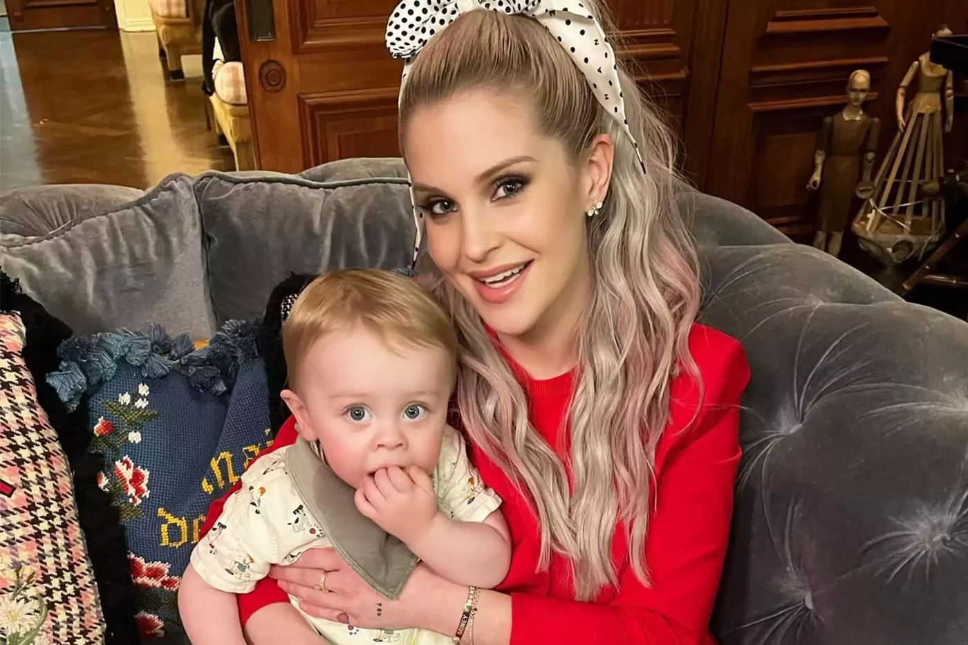 Kelly Osbourne smiles with her son Sidney at work.