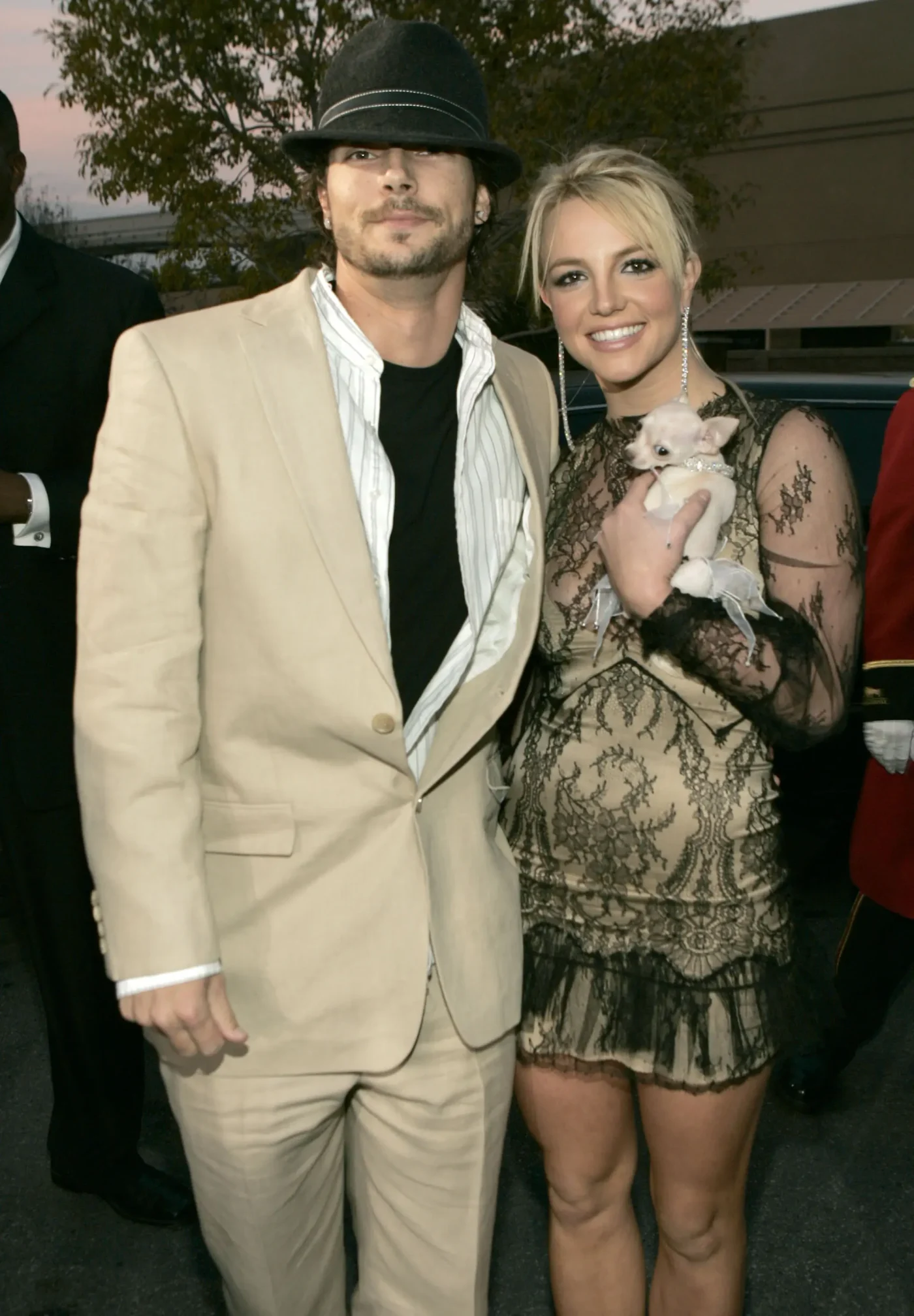 Kevin Federline and Britney Spears on the red carpet, with Britney holding a small dog.